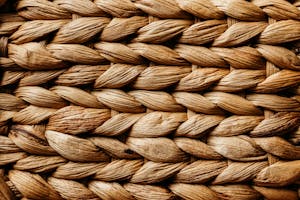 Detailed close-up of a braided natural fiber texture showcasing intricate patterns.